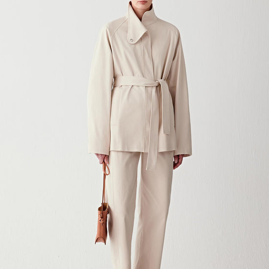 Video showing walking movement, emphasizing structured drape, slight stretch and clean silhouette