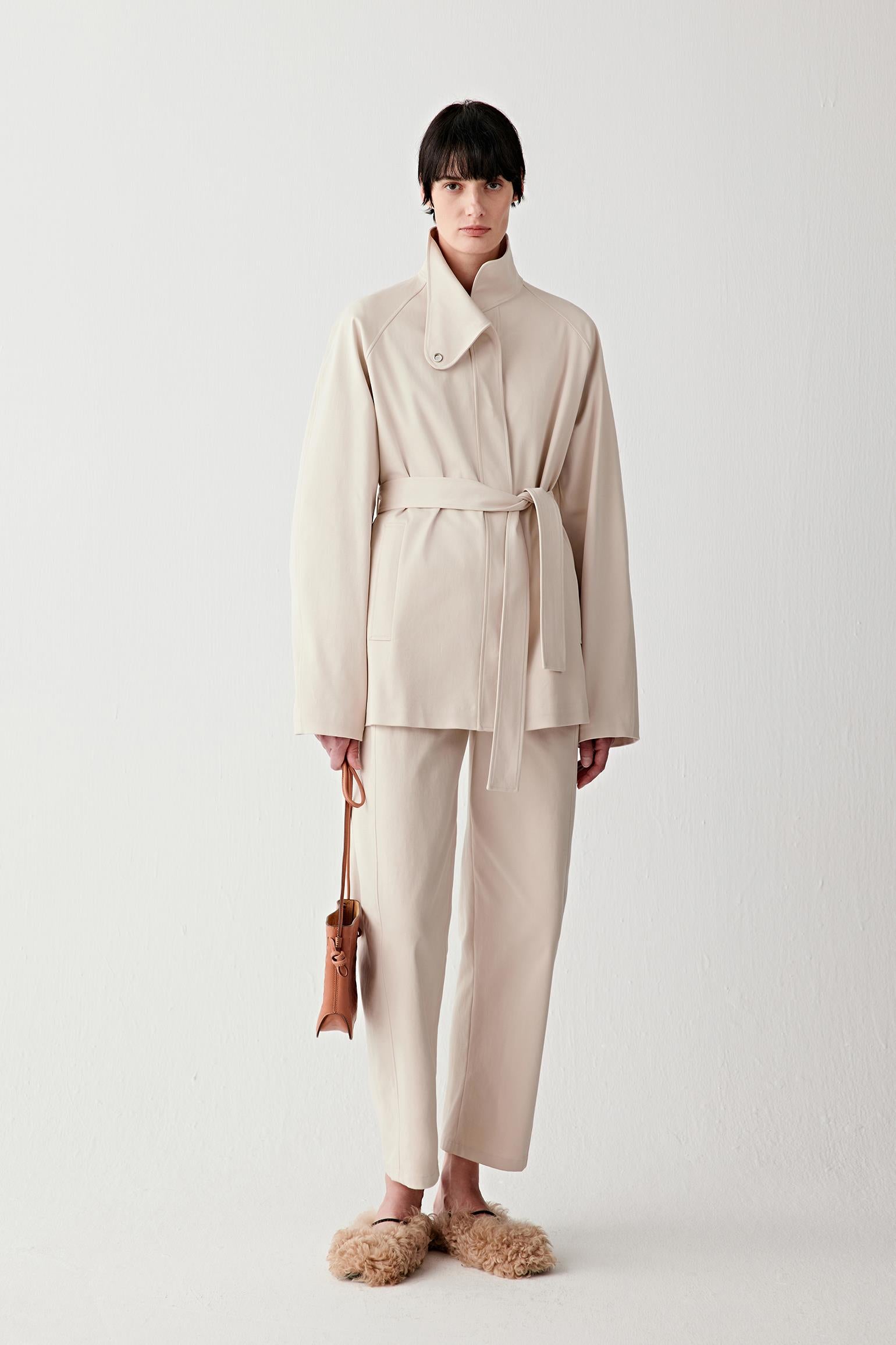 Video showing walking movement, emphasizing structured drape, slight stretch and clean silhouette