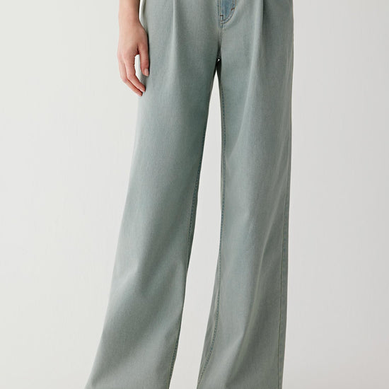 Video showing the model walking in a relaxed pace, highlighting the fluid movement of the lightweight stretch denim, the flexibility of the fabric through the hips and knees, and the way the wide-leg silhouette opens and closes with each step