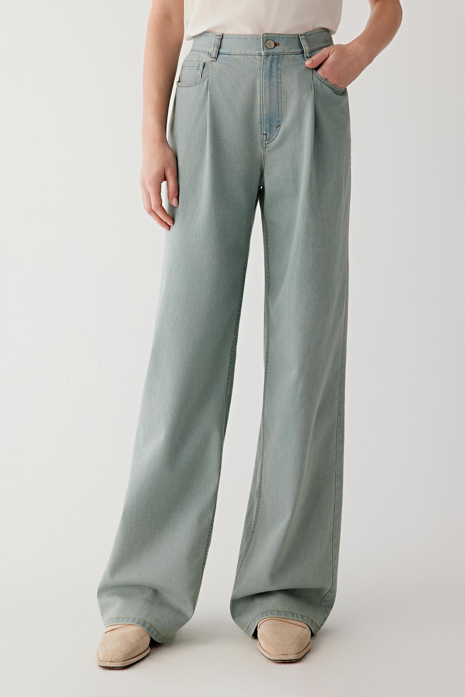 Video showing the model walking in a relaxed pace, highlighting the fluid movement of the lightweight stretch denim, the flexibility of the fabric through the hips and knees, and the way the wide-leg silhouette opens and closes with each step