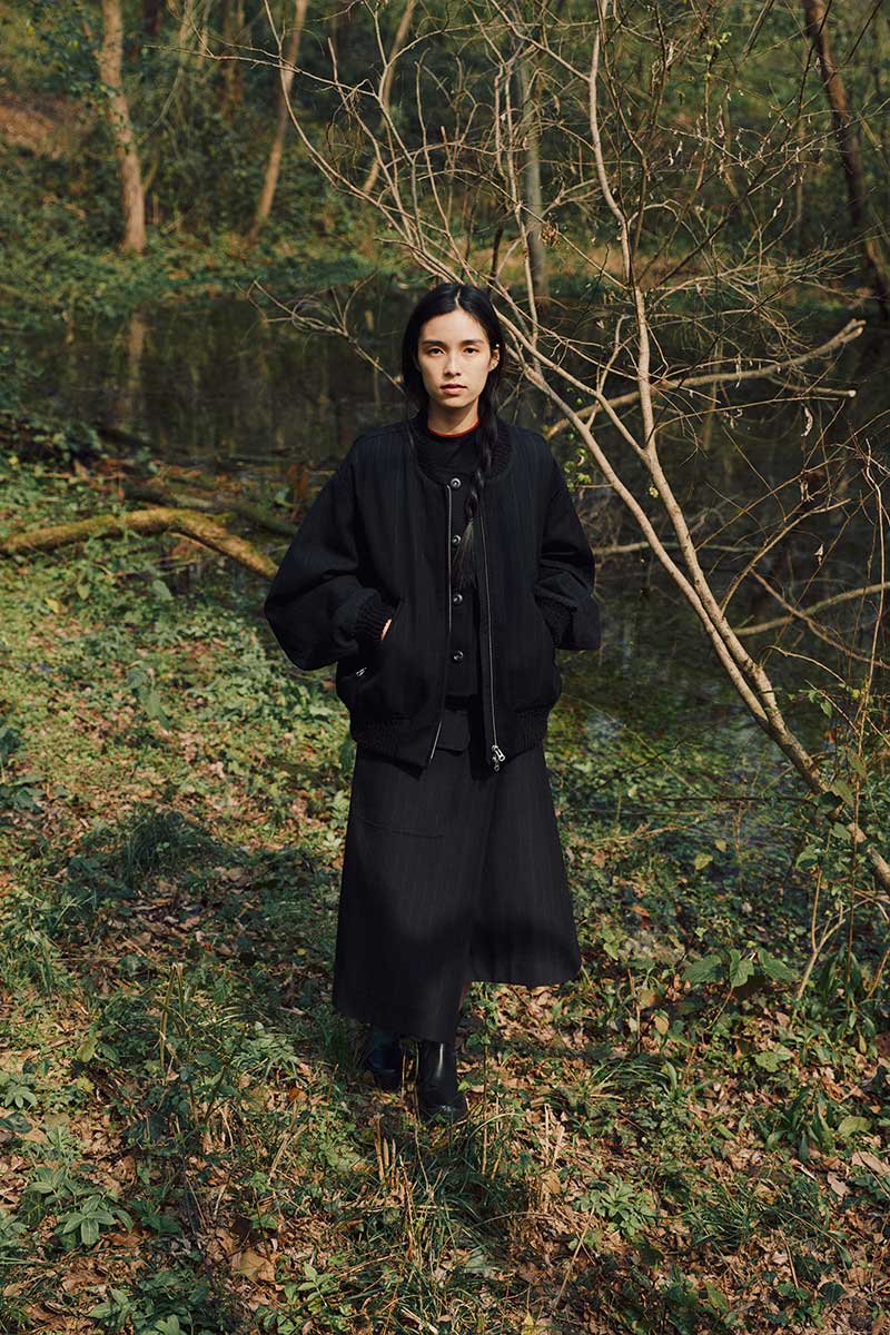 woman standing in forest