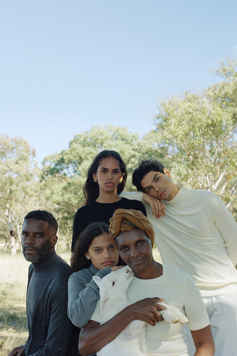 group of people holding lamb